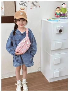 Close-up of pink cartoon rabbit chest bag styled with kids denim jacket and beige cap