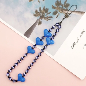 Detail of blue heart-shaped acrylic beads and black-and-white striped phone charm