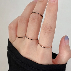 Minimalist rose gold titanium ring set with thin black enamel line for women