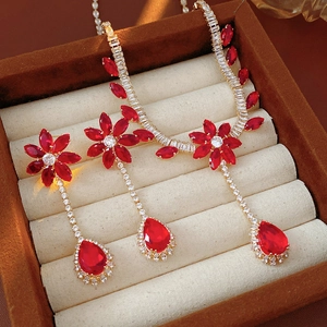 Detailed view of luxury jewelry set with red zircon flowers and water drop pendants