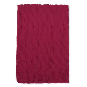 Detailed texture of dark burgundy crinkle cotton scarf with wavy edge on white background