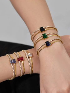 Detail view of double-layer gold bracelets with rectangular colorful zircon stones