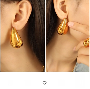 Exaggerated liquid gold teardrop earrings shown in side profile on a model