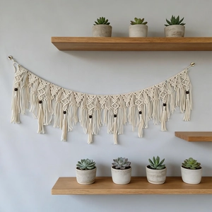 Handmade macrame wall hanging with wooden beads and tassels for boho home decor