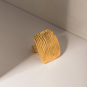 Macro shot of 18K gold plated stainless steel ring with rectangular textured surface