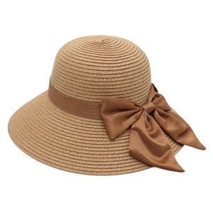 Elegant wide brim straw sun hat with large brown ribbon bow for women's beach vacation