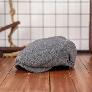 Grey wool blend newsboy cap with vintage texture and side profile view for autumn