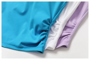 Detail of ruched side seams and stitching on breathable yoga tanks in three colors