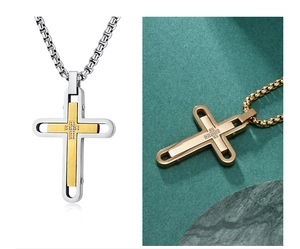 Macro shot of two-tone stainless steel cross pendant with inset crystal and gold plating