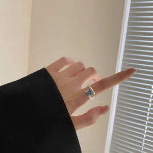 Irregular S925 sterling silver open ring with large square blue cubic zirconia on finger