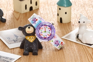 Close-up of kids waterproof quartz watch with purple cartoon insect and floral strap