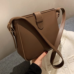 Classic dark brown PU leather bucket bag with flap closure and adjustable shoulder strap