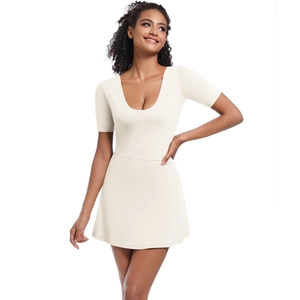 Detailed close-up of a slim fit beige tennis dress with U-neckline and short sleeves