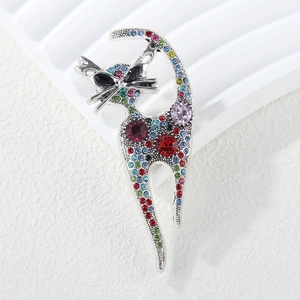Exquisite retro cat brooch in silver metal with colorful rhinestones on white background