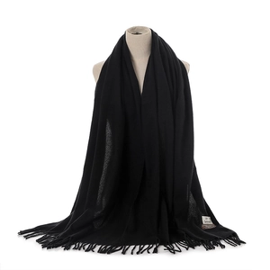 Black solid color faux cashmere winter warm tassel scarf for women daily wear detail view.