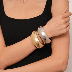 Minimalist wide chunky metal bangle in polished gold and silver finish for women