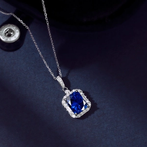 Macro shot of S925 silver necklace featuring a deep blue emerald-cut zircon pendant