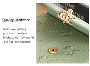 Detailed macro view of green leather wallet with floral embroidery and gold hardware