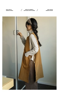 Detail of vintage brown cotton linen apron with adjustable side ties and large pocket