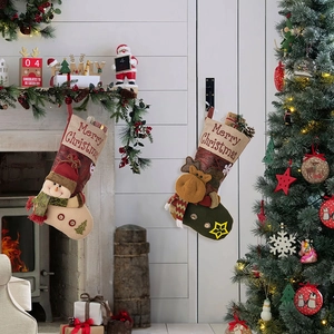 Macro detail of Christmas stockings with snowman and reindeer patterns hanging by fireplace