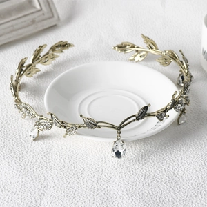 Detail of gold leaf bridal crown with rhinestones and a water drop crystal pendant