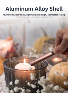 Rose gold pulse arc lighter igniting a scented candle with cozy autumn decor