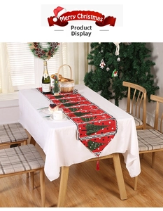 Detailed Christmas table runner with festive tree prints and red tassels decoration