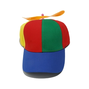 Detail of multi-color propeller hat featuring a spinning orange blade and vibrant panels