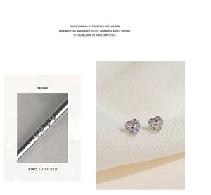 Macro detail of S925 sterling silver stamp and pink heart-shaped stud earrings