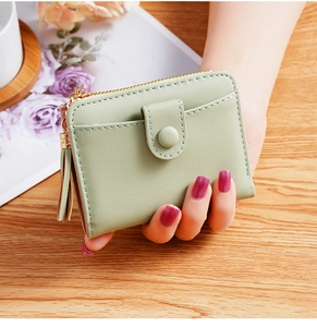 Detailed view of light green PU leather mini wallet with tassel zipper and snap button