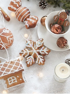 Close-up of gingerbread man and snowflake ornaments for Christmas tree decor