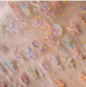 Macro detail of bronzing butterfly nail stickers with iridescent finish and gold lines