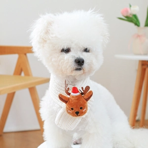 Detail of soft knit white pet scarf featuring a plush reindeer charm for dogs and cats