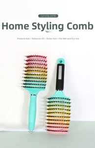 Detail of curved vented hairbrush with colorful gradient bristles and non-slip green handle