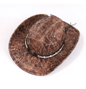 Detail of distressed brown suede cowboy hat with woven leather band and bronze emblem