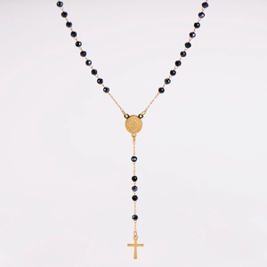 Detailed close-up of a rosary necklace with black faceted beads and a golden crucifix
