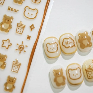 3D bronzing bear nail stickers with cartoon stars and sun patterns on cream nails