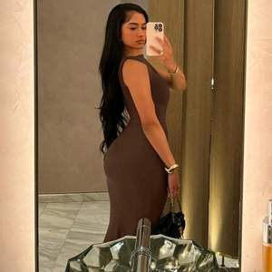 Detailed texture of brown sleeveless bodycon dress with side ruched pleated fabric