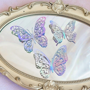 Detailed view of hollow laser butterfly decorations on a vintage mirror surface