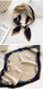 Macro detail of French retro silk scarf with pleated texture and chain patterns