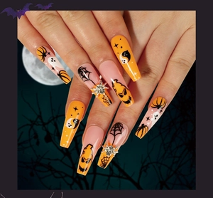 Detailed view of Halloween press on nails with pumpkin ghost and spider rhinestone motifs