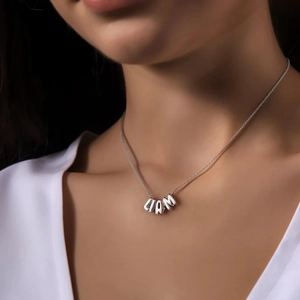 Silver tone brass necklace featuring a custom LIAM bubble letter pendant on model