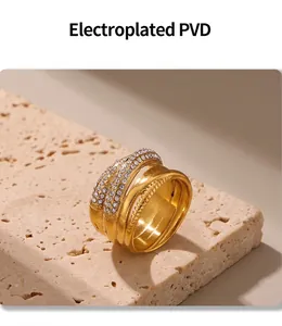 Macro detail of gold braided ring with crystals on beige travertine stone