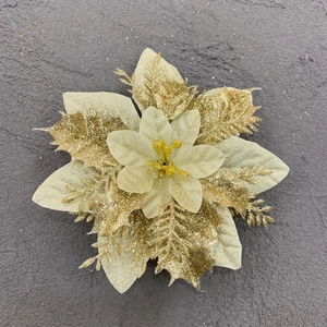 Macro shot of sparkling gold artificial poinsettia flower with glitter for Christmas decor