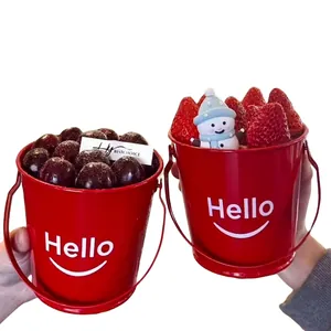 Red mini festive tin bucket with snowman and fresh strawberries for Christmas party decor