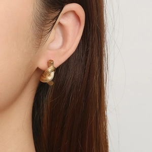 Chic 18K gold plated stainless steel twisted knot earrings shown on a model
