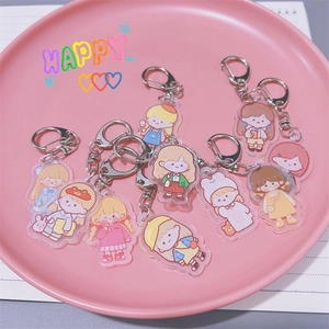 Cute acrylic cartoon girl keychains set for backpacks and headphone cases on pink tray