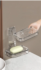 Detail showing detachable clear trays of the wall-mounted soap box for easy cleaning