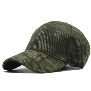 Macro shot of the army green ribbed fabric and six-panel stitching of the baseball cap