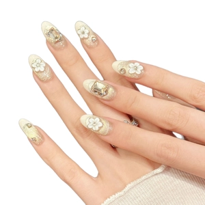 Champagne gold glitter press-on nails with 3D white flowers and rhinestone accents